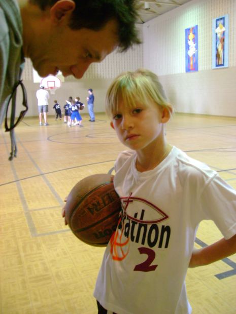 Father and daughter on basketball court