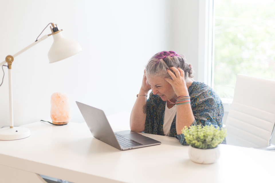 a woman sitting at a table with the hands on the face